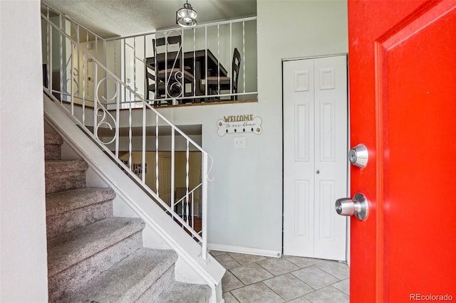 1733 S Nucla St, Aurora, CO 80017 - stairway featuring tile patterned flooring and a textured ceiling