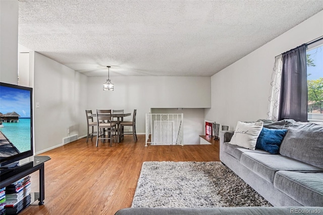 1733 S Nucla St, Aurora, CO 80017 - living area featuring wood finished floors and a textured ceiling
