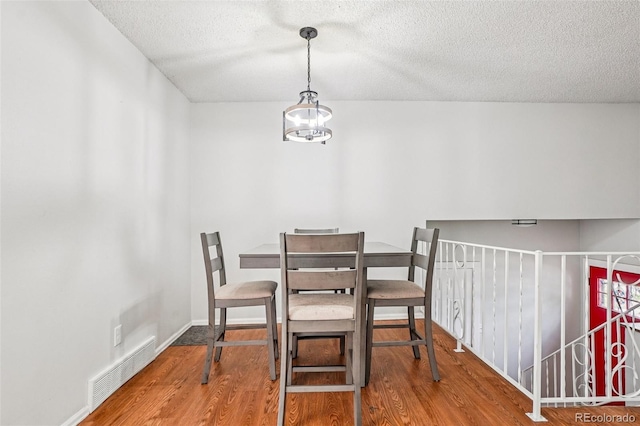 1733 S Nucla St, Aurora, CO 80017 - dining area featuring a textured ceiling and wood finished floors