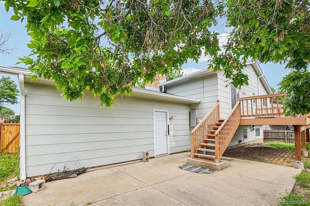 1733 S Nucla St, Aurora, CO 80017 - rear view of property featuring stairs, a patio area, and a wooden deck