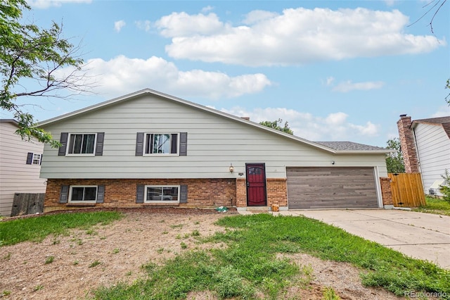 1733 S Nucla St, Aurora, CO 80017 - view of front of home with a garage, concrete driveway, and brick siding
