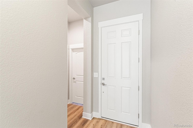 corridor with light wood-type flooring