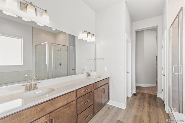 bathroom featuring vanity, a shower with shower door, and hardwood / wood-style floors