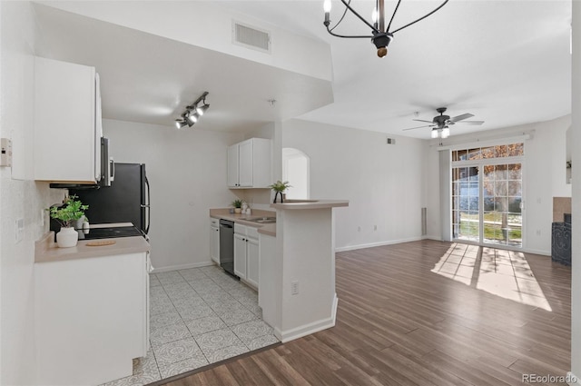 kitchen featuring white cabinets, dishwasher, light hardwood / wood-style floors, kitchen peninsula, and ceiling fan with notable chandelier