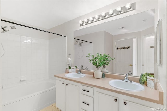 bathroom featuring vanity and tiled shower / bath