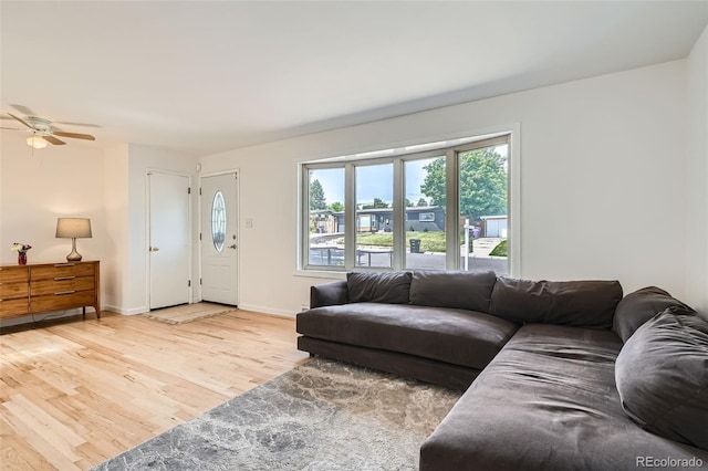 2692 S Osceola St, Denver, CO 80219 - living area featuring wood finished floors, healthy amount of natural light, and a ceiling fan
