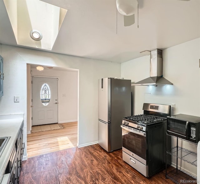 2692 S Osceola St, Denver, CO 80219 - kitchen with appliances with stainless steel finishes, wall chimney exhaust hood, and dark wood-style flooring
