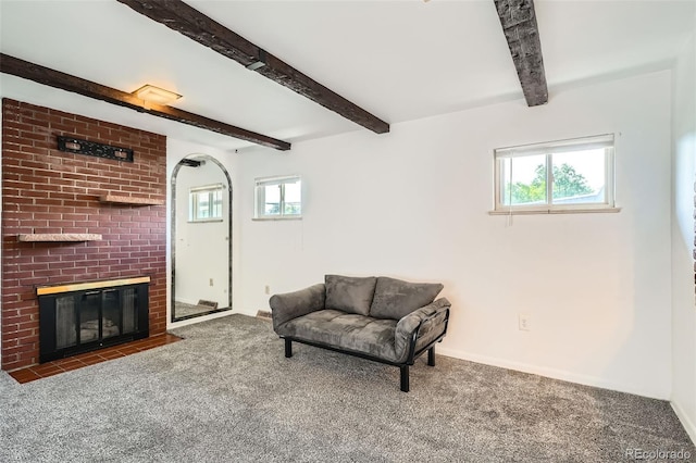 2692 S Osceola St, Denver, CO 80219 - living area with beamed ceiling, carpet, healthy amount of natural light, and a fireplace