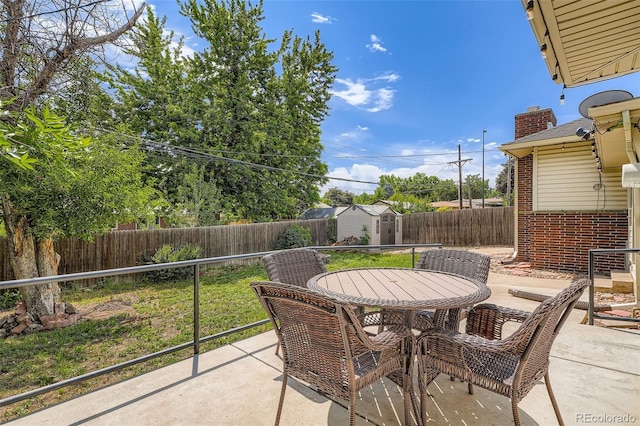 2692 S Osceola St, Denver, CO 80219 - fenced backyard featuring outdoor dining space, a storage shed, and a patio