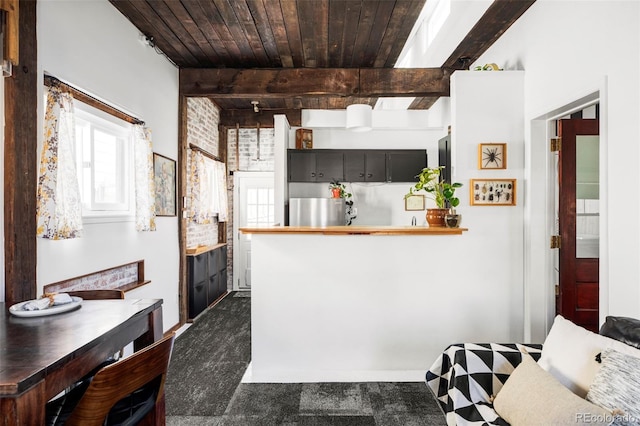 kitchen featuring freestanding refrigerator, wood ceiling, and beam ceiling