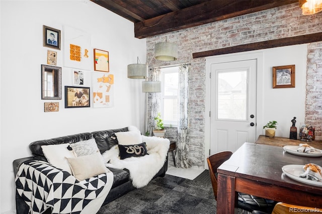 living room with wood ceiling, brick wall, and beamed ceiling