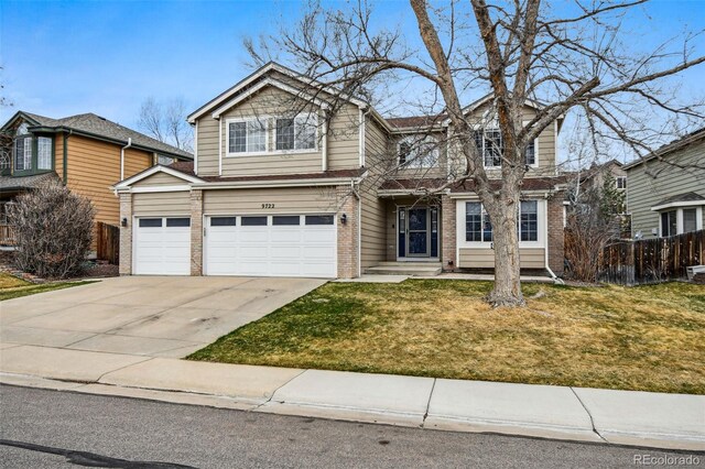 view of front facade featuring brick siding, concrete driveway, fence, and a front yard