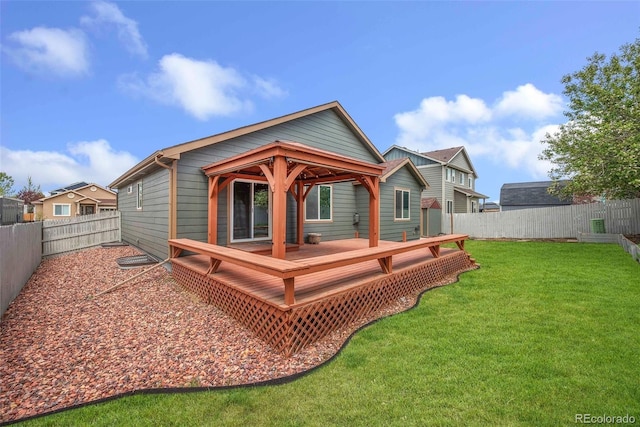 rear view of property featuring a fenced backyard, a wooden deck, and a yard