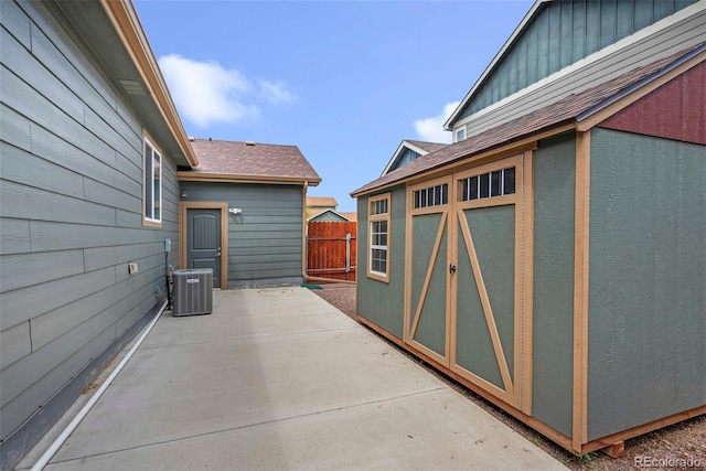 view of patio / terrace with central AC unit and fence