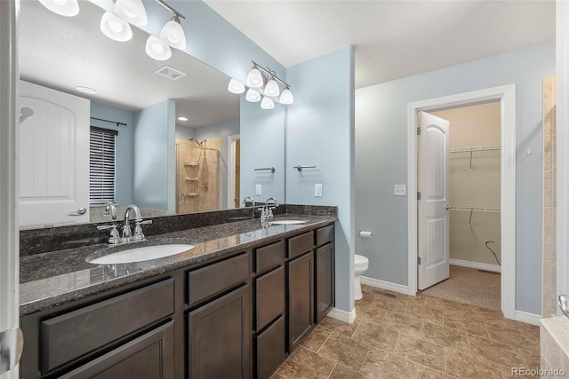 full bath featuring visible vents, a sink, a walk in closet, and toilet