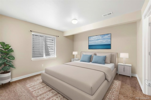 bedroom featuring baseboards, light carpet, and visible vents