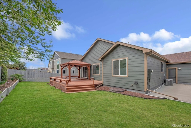 rear view of house with a gazebo, a deck, a fenced backyard, central AC unit, and a lawn