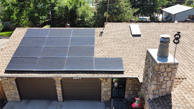 8644 S Brentwood St, Littleton, CO 80128 - exterior view of a shingled roof, stone siding, and concrete driveway