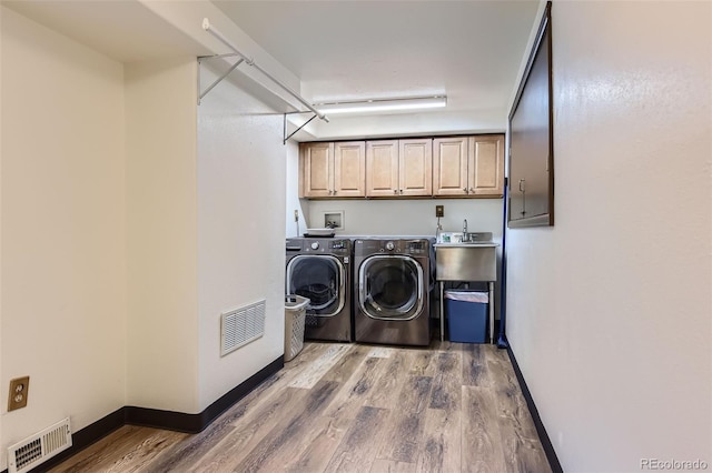 8644 S Brentwood St, Littleton, CO 80128 - laundry room featuring cabinet space, washer and dryer, and wood finished floors