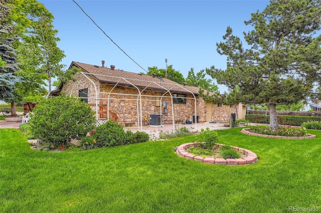 8644 S Brentwood St, Littleton, CO 80128 - back of house with stone siding and a lawn