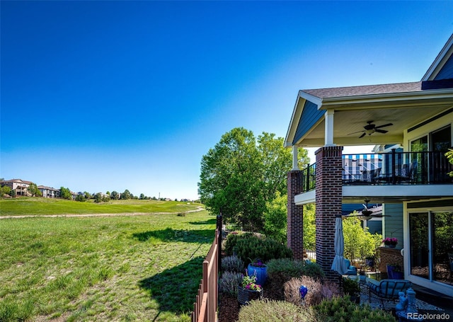 22685 E Calhoun Pl, Aurora, CO 80016 - view of green lawn featuring a ceiling fan and a balcony