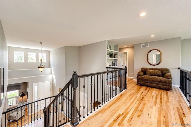 22685 E Calhoun Pl, Aurora, CO 80016 - hall featuring an upstairs landing, wood finished floors, recessed lighting, and baseboards