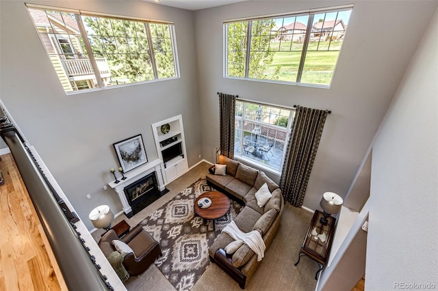 22685 E Calhoun Pl, Aurora, CO 80016 - living room featuring a high ceiling and a fireplace with flush hearth