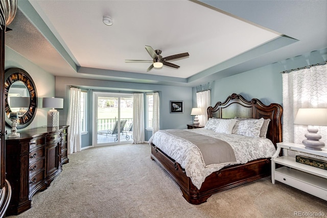 22685 E Calhoun Pl, Aurora, CO 80016 - bedroom with a tray ceiling, access to exterior, carpet floors, a ceiling fan, and baseboards