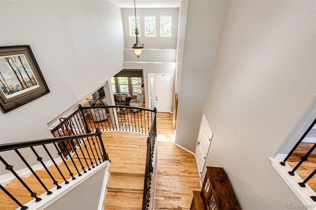 22685 E Calhoun Pl, Aurora, CO 80016 - stairs featuring a high ceiling, wood finished floors, and baseboards