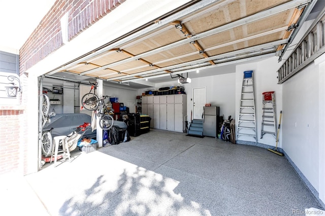 22685 E Calhoun Pl, Aurora, CO 80016 - garage with freestanding refrigerator, a garage door opener, and baseboards