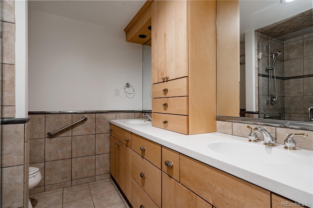 420 S Marion Pkwy Unit 203, Denver, CO 80209 - full bath featuring double vanity, tile walls, tile patterned floors, tiled shower, and a wainscoted wall