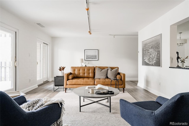 420 S Marion Pkwy Unit 203, Denver, CO 80209 - living area featuring wood finished floors and rail lighting