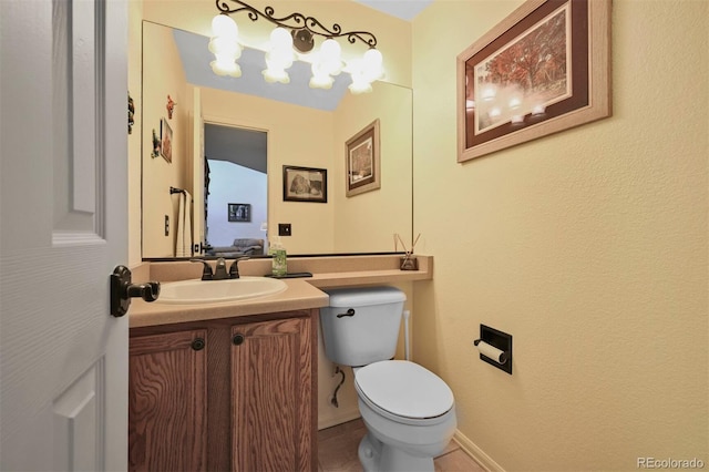 half bath featuring vanity, toilet, and tile patterned floors