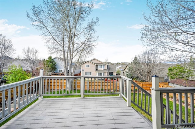 deck with a residential view and a fenced backyard
