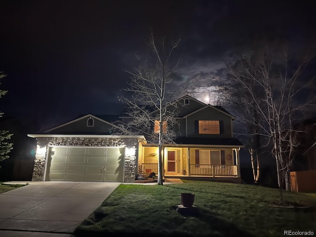 traditional home featuring driveway, a porch, an attached garage, and stone siding