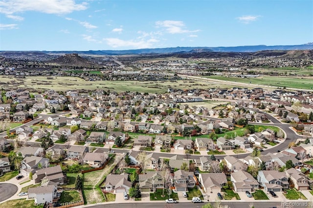 view of property location with a mountainous background and nearby suburban area