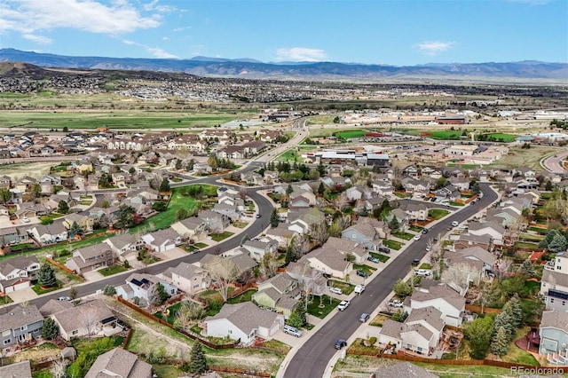 aerial view of property and surrounding area featuring nearby suburban area and mountains