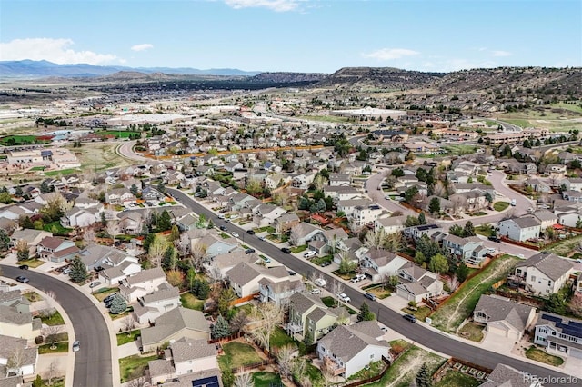 aerial view of property's location with nearby suburban area and mountains