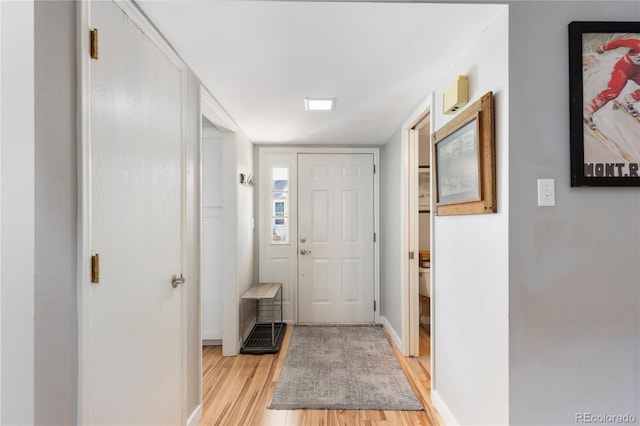 entrance foyer featuring baseboards and light wood-style floors