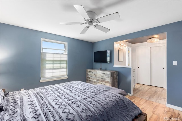 bedroom featuring a ceiling fan, baseboards, and wood finished floors