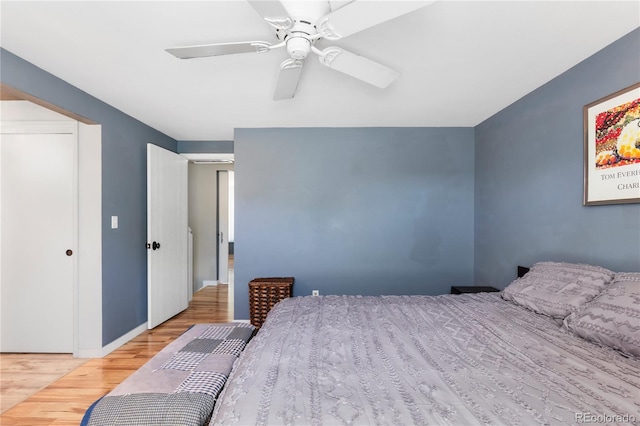 bedroom with ceiling fan, baseboards, and wood finished floors