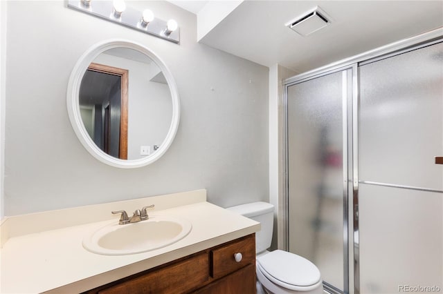 full bathroom with toilet, vanity, visible vents, and a shower stall