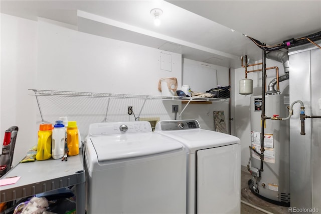 clothes washing area featuring water heater, laundry area, and washing machine and clothes dryer