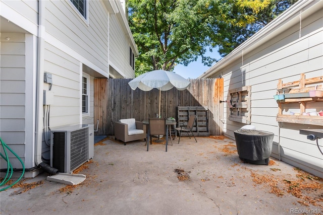 view of patio / terrace featuring central AC unit and fence