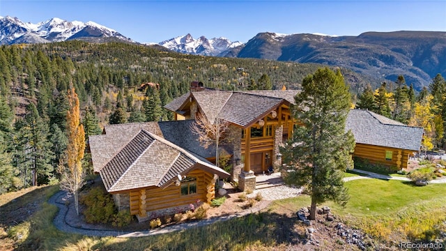 view of front of house with a mountain view and a front lawn