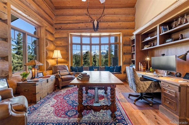 office area featuring log walls, high vaulted ceiling, light hardwood / wood-style flooring, and wood ceiling