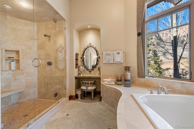 bathroom with tile patterned floors and independent shower and bath