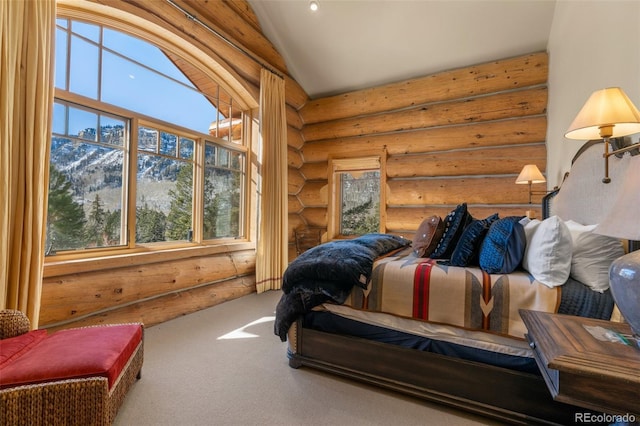 carpeted bedroom featuring a mountain view, rustic walls, and lofted ceiling