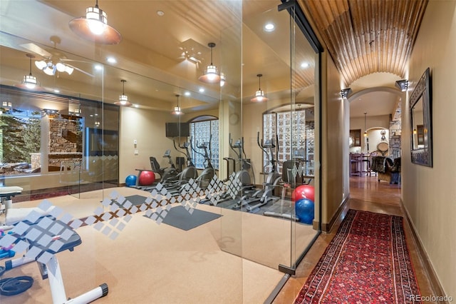 exercise room with ceiling fan