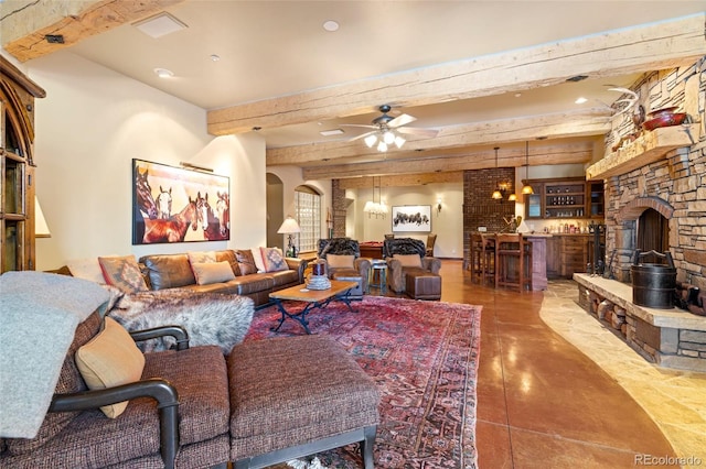 living room with beamed ceiling, ceiling fan, and indoor bar